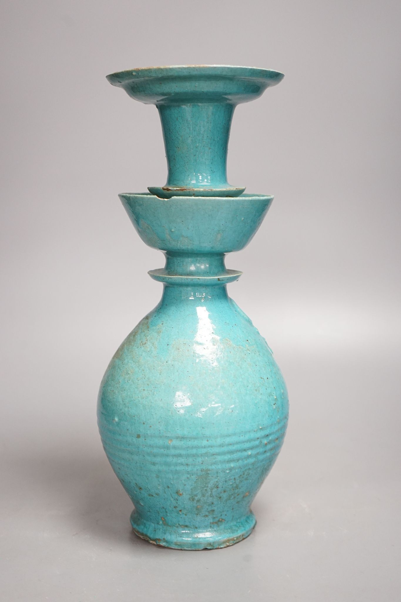 A Persian turquoise glazed huqqa base, 17th century or later, 33cm